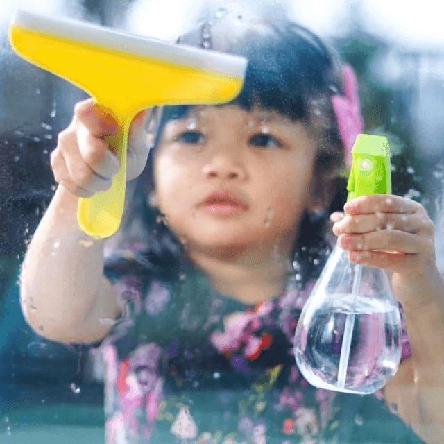 Child using the Squeaky Clean Squeegee Set from The Enthusiast Play Kit