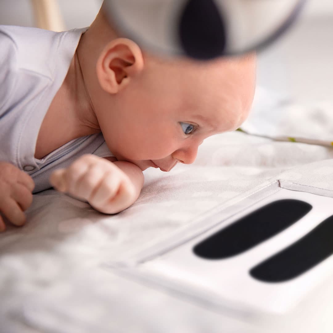 Baby doing tummy time on The Play Gym by Lovevery