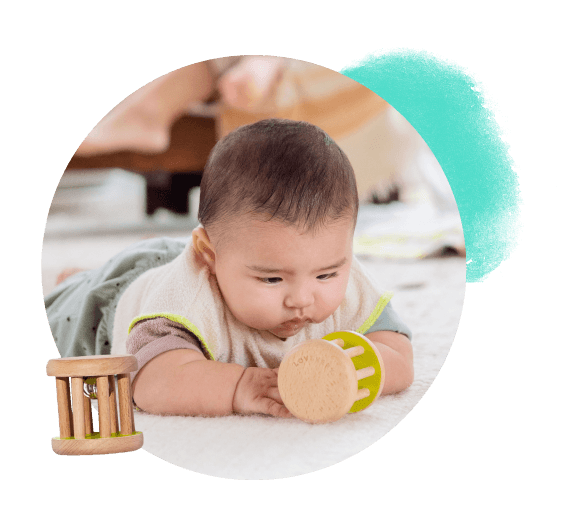 Baby looking at the Rolling Bell from The Charmer Play Kit